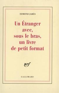 Un Etranger avec, sous les bras, un livre de petit format